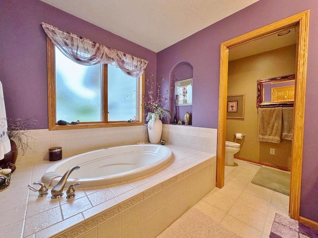 2900 8th St, Minot, ND 58701 - bathroom featuring toilet, a garden tub, and tile patterned floors