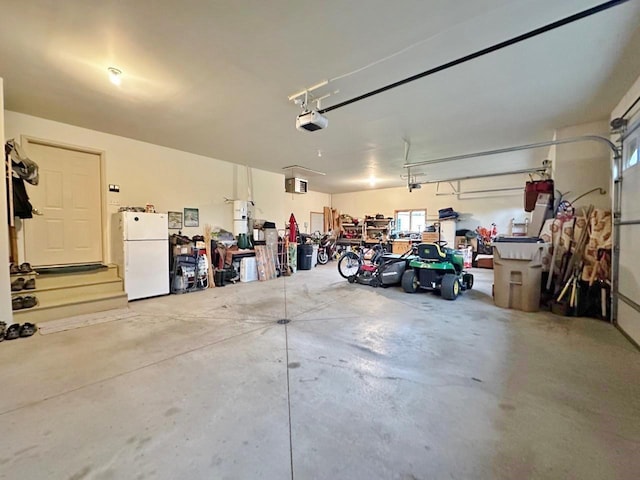 2900 8th St, Minot, ND 58701 - garage featuring freestanding refrigerator and a garage door opener