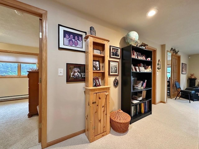 2900 8th St, Minot, ND 58701 - hall with carpet, a baseboard radiator, baseboards, and recessed lighting