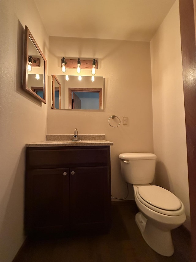 1003 NW Harrison Dr, Minot, ND 58703 - bathroom with toilet and vanity