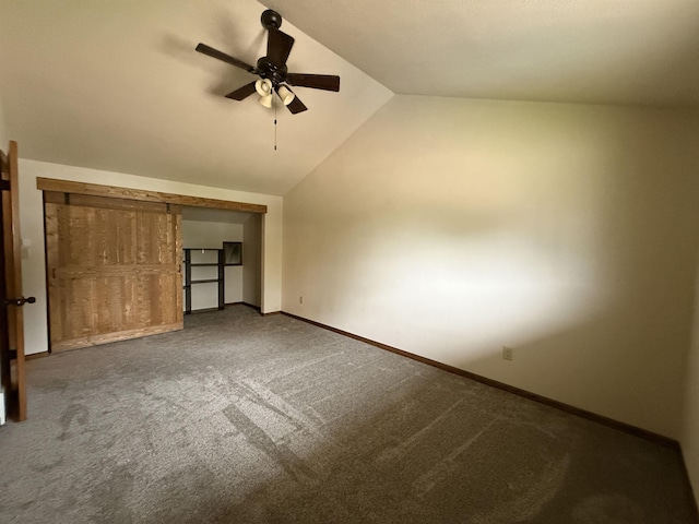 1003 NW Harrison Dr, Minot, ND 58703 - unfurnished bedroom with carpet floors, vaulted ceiling, baseboards, and a ceiling fan