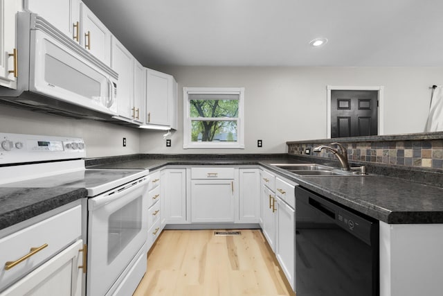1111 15th St, Minot, ND 58703 - kitchen with white appliances, a sink, light wood-type flooring, white cabinets, and recessed lighting