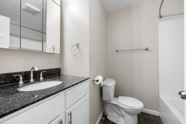 1111 15th St, Minot, ND 58703 - bathroom featuring toilet, vanity, baseboards, and tile patterned floors