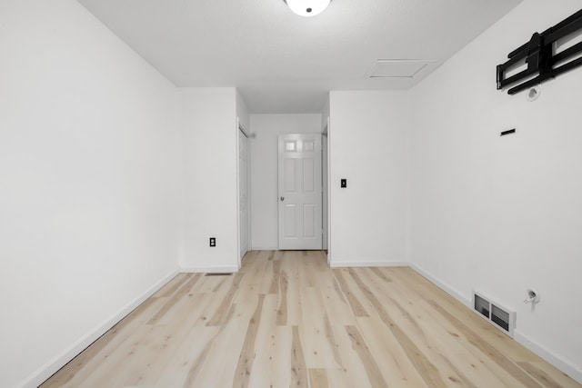 1111 15th St, Minot, ND 58703 - empty room with attic access, wood finished floors, and baseboards