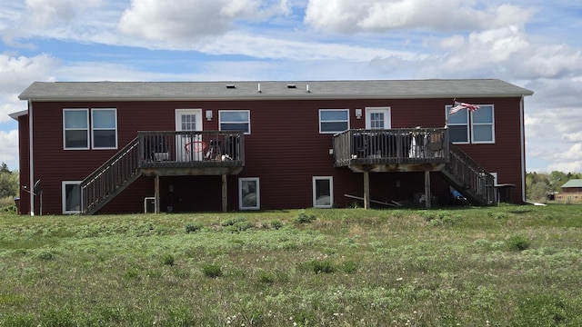 1512 47th Loop, Minot, ND 58701 - rear view of property with stairway and a wooden deck