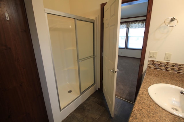 1512 47th Loop, Minot, ND 58701 - bathroom featuring a shower stall and double vanity