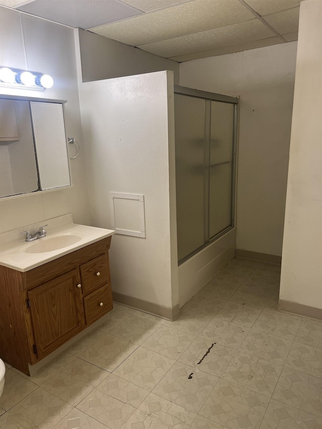 912 Valley St, Minot, ND 58701 - bathroom featuring a shower with door, vanity, baseboards, and toilet