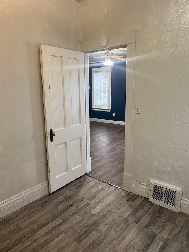 912 Valley St, Minot, ND 58701 - unfurnished room featuring dark wood-type flooring, ceiling fan, baseboards, and a smoke detector