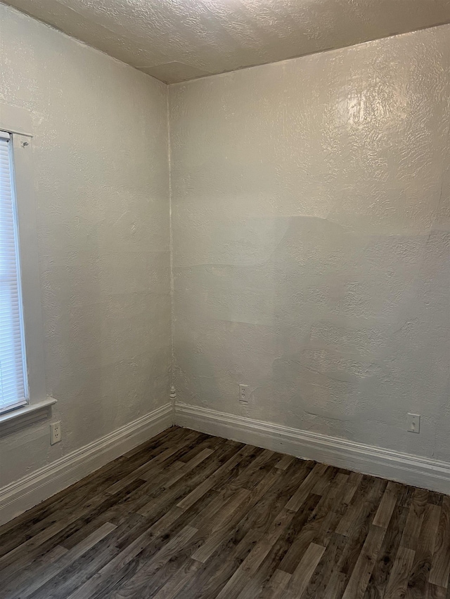 912 Valley St, Minot, ND 58701 - empty room featuring dark wood-style flooring and baseboards