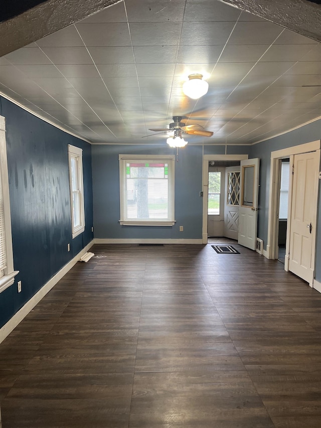 912 Valley St, Minot, ND 58701 - unfurnished room featuring a ceiling fan, dark wood-type flooring, and baseboards