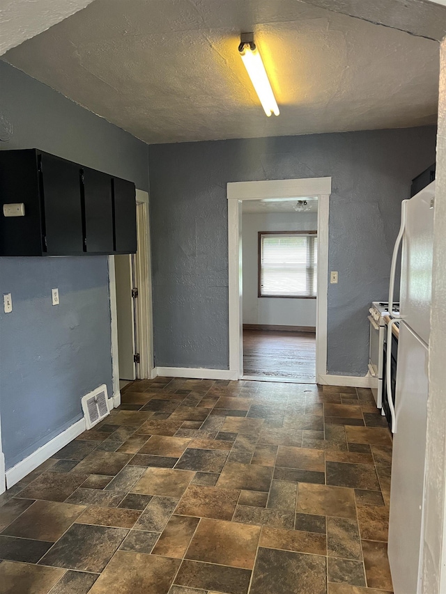 912 Valley St, Minot, ND 58701 - washroom featuring a textured ceiling and baseboards