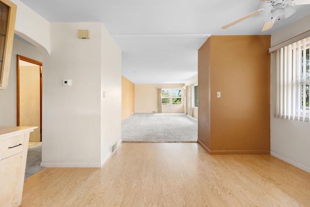 1200 9th St, Minot, ND 58703 - corridor featuring light wood-style floors, arched walkways, and baseboards
