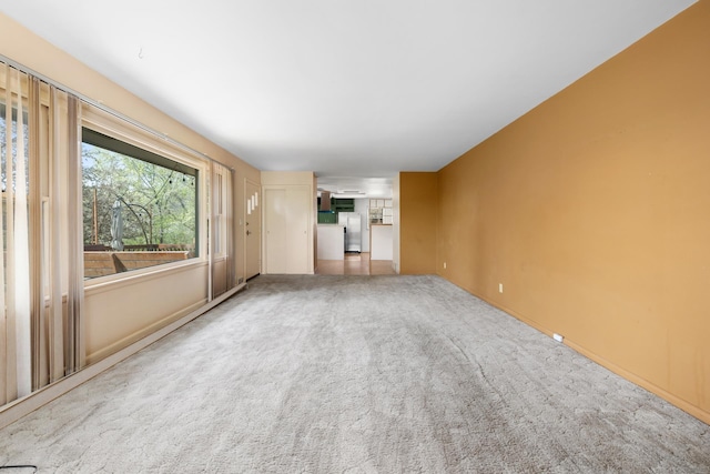 1200 9th St, Minot, ND 58703 - unfurnished living room featuring carpet and baseboards