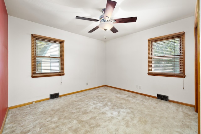 1200 9th St, Minot, ND 58703 - spare room featuring healthy amount of natural light, carpet floors, and baseboards