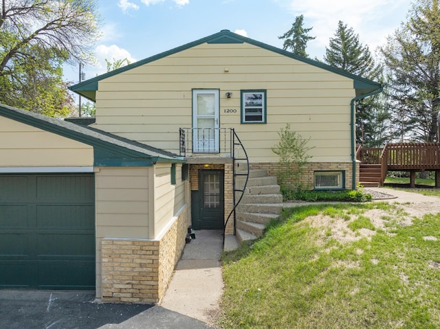 1200 9th St, Minot, ND 58703 - view of front of home with a deck and an attached garage