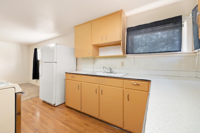 1200 9th St, Minot, ND 58703 - kitchen featuring freestanding refrigerator, a sink, light wood finished floors, stove, and light countertops