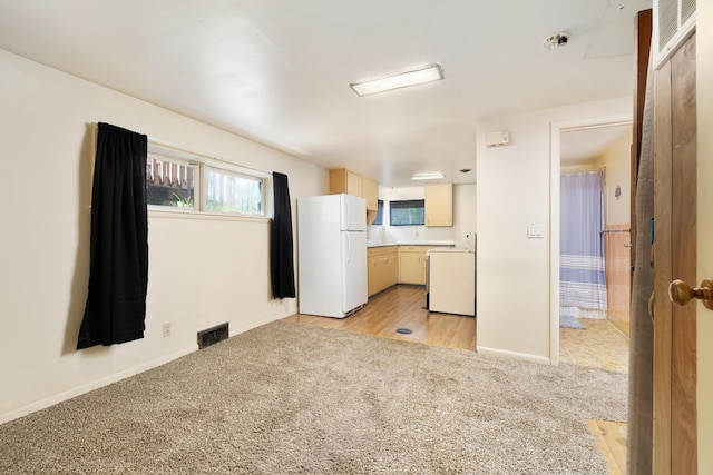 1200 9th St, Minot, ND 58703 - kitchen featuring freestanding refrigerator, light carpet, baseboards, and light countertops