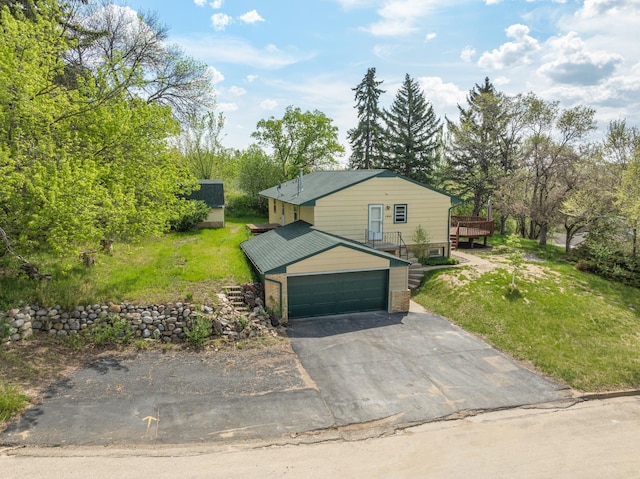 1200 9th St, Minot, ND 58703 - view of front facade with driveway, a front yard, and a deck