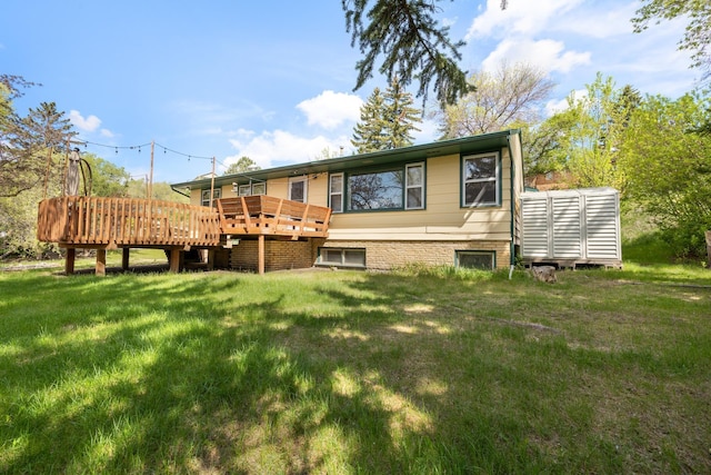 1200 9th St, Minot, ND 58703 - back of property featuring a deck and a lawn
