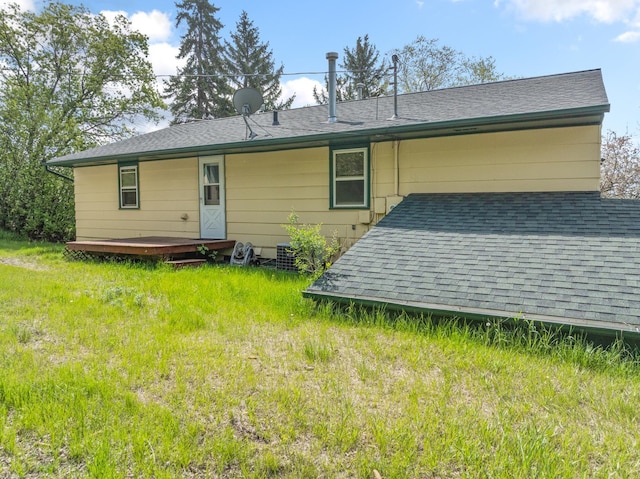 1200 9th St, Minot, ND 58703 - back of house featuring a shingled roof and a wooden deck