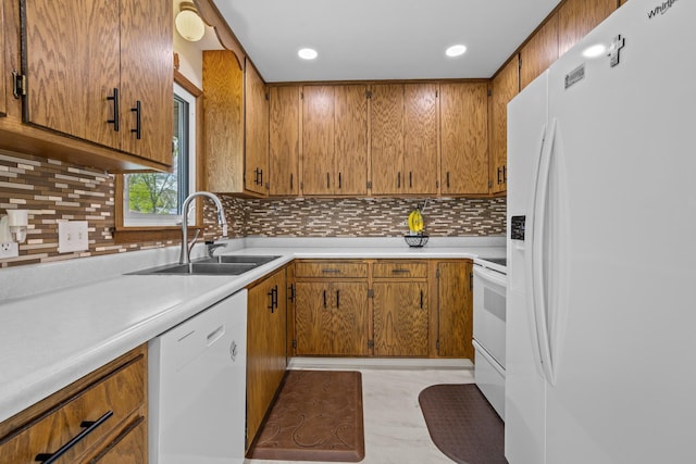 1213 Sunset Blvd, Minot, ND 58703 - kitchen featuring white appliances, a sink, light countertops, brown cabinetry, and recessed lighting