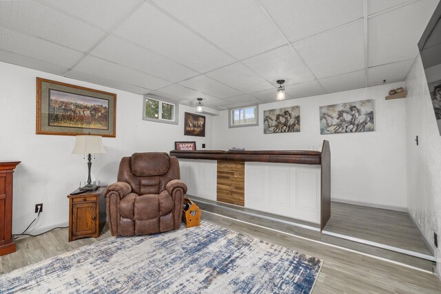 1213 Sunset Blvd, Minot, ND 58703 - sitting room featuring a paneled ceiling, light wood-type flooring, and baseboards