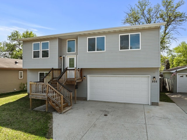 205 17th St, Minot, ND 58703 - bi-level home featuring driveway, a garage, and a front lawn