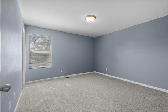 205 17th St, Minot, ND 58703 - carpeted empty room with baseboards