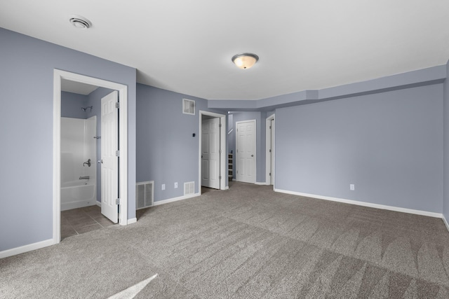 205 17th St, Minot, ND 58703 - unfurnished bedroom featuring carpet, baseboards, and connected bathroom