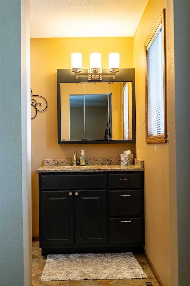 3700 10th Ave, Minot, ND 58701 - bathroom with vanity and baseboards