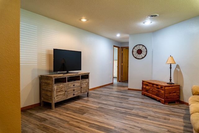 3700 10th Ave, Minot, ND 58701 - living area featuring wood finished floors, baseboards, recessed lighting, and a textured ceiling