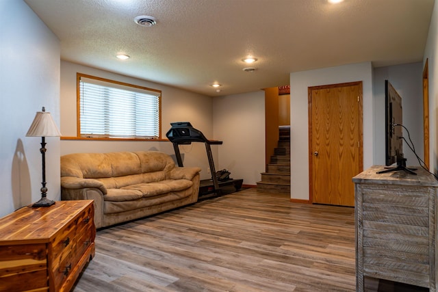 3700 10th Ave, Minot, ND 58701 - living area featuring light wood-style floors, stairs, a textured ceiling, and recessed lighting