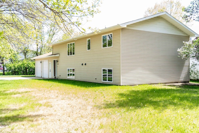 3700 10th Ave, Minot, ND 58701 - back of property with driveway, a garage, and a lawn