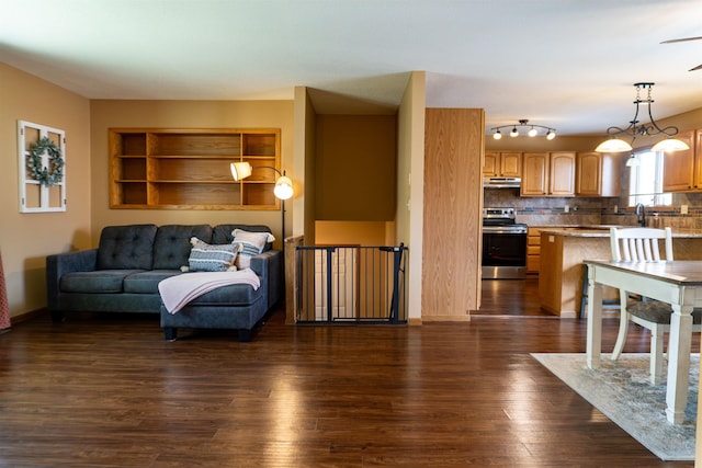 3700 10th Ave, Minot, ND 58701 - living room with dark wood-style flooring, ceiling fan, and built in features