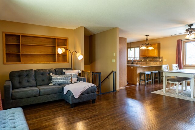 3700 10th Ave, Minot, ND 58701 - living room with dark wood-style floors, ceiling fan, and a chandelier