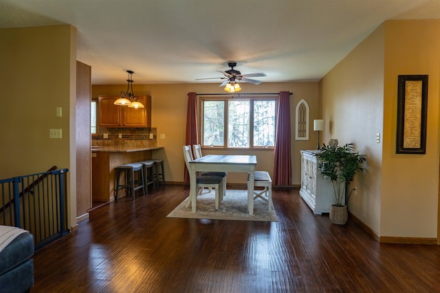 3700 10th Ave, Minot, ND 58701 - dining room with dark wood finished floors, a ceiling fan, and baseboards