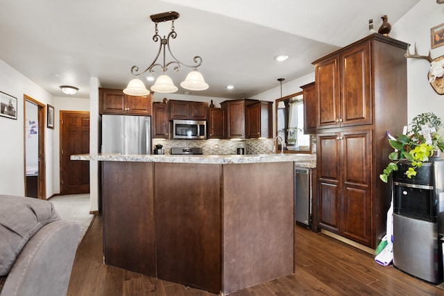 6351 53rd St, Plaza, ND 58771 - kitchen featuring stainless steel appliances, light countertops, decorative backsplash, dark wood-style flooring, and a kitchen island