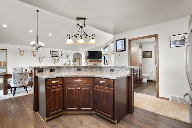 6351 53rd St, Plaza, ND 58771 - kitchen featuring dark wood finished floors, dark brown cabinets, pendant lighting, arched walkways, and vaulted ceiling