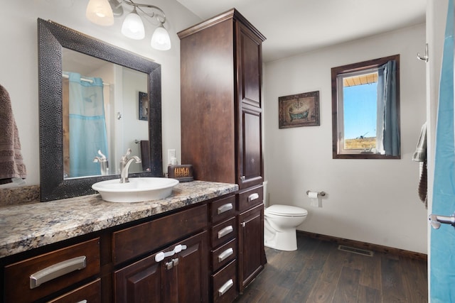6351 53rd St, Plaza, ND 58771 - full bath featuring vanity, wood finished floors, toilet, baseboards, and curtained shower