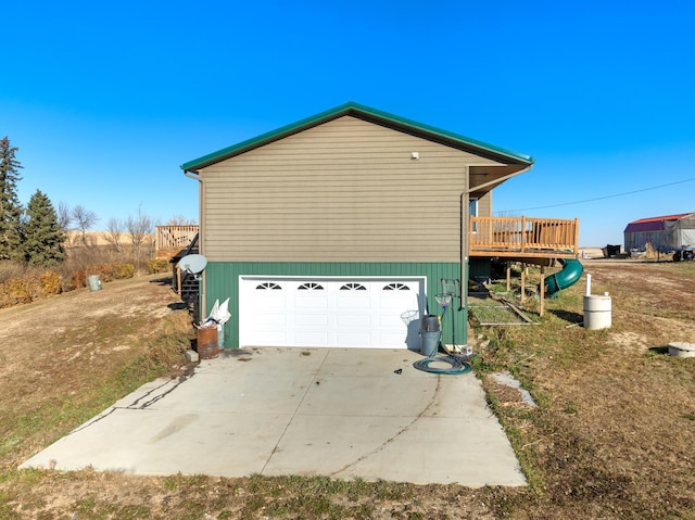 6351 53rd St, Plaza, ND 58771 - view of side of home with a wooden deck, an attached garage, and concrete driveway