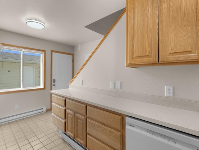 2301 2nd Ave Unit 2, Minot, ND 58701 - kitchen featuring white dishwasher, light countertops, baseboard heating, light tile patterned flooring, and light brown cabinetry