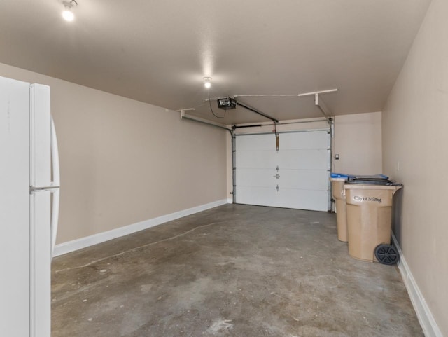 2301 2nd Ave Unit 2, Minot, ND 58701 - garage with freestanding refrigerator, a garage door opener, and baseboards