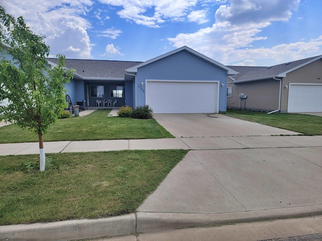 5304 15th Ave, Minot, ND 58701 - ranch-style home with a garage, driveway, a front yard, and a shingled roof