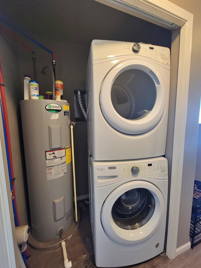 5304 15th Ave, Minot, ND 58701 - washroom featuring electric water heater, stacked washing machine and dryer, wood finished floors, and baseboards