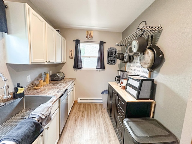 101 6th St, Minot, ND 58703 - kitchen with dishwasher, a baseboard heating unit, a sink, light wood-style flooring, and white cabinetry