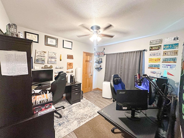 101 6th St, Minot, ND 58703 - home office with ceiling fan, wood finished floors, and a textured ceiling