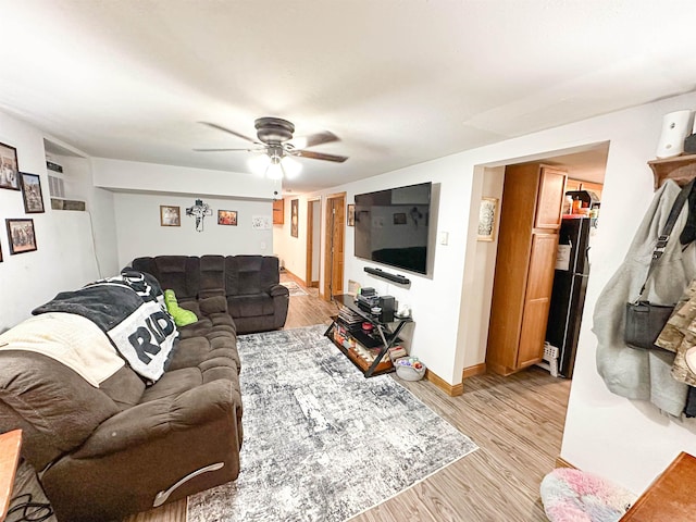 101 6th St, Minot, ND 58703 - living area featuring a ceiling fan, light wood finished floors, and baseboards