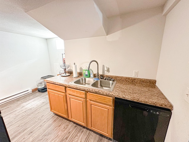 101 6th St, Minot, ND 58703 - kitchen with black dishwasher, a sink, light wood finished floors, a baseboard radiator, and a peninsula
