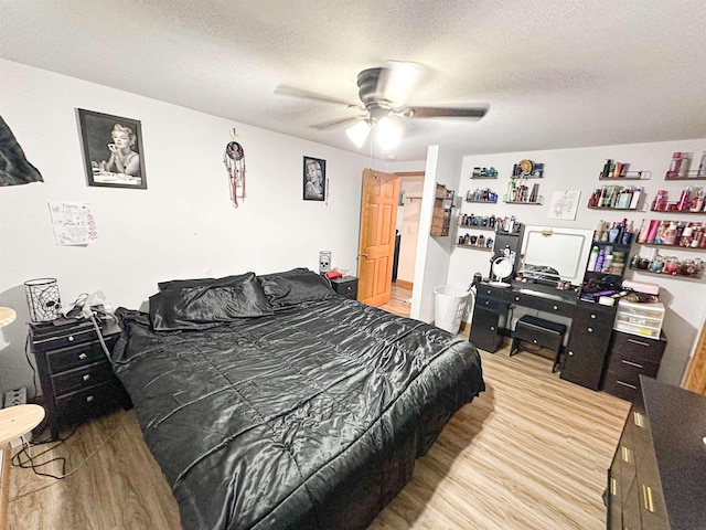 101 6th St, Minot, ND 58703 - bedroom featuring light wood-style flooring, a textured ceiling, and ceiling fan