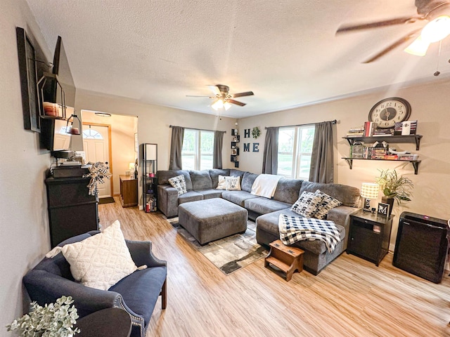 101 6th St, Minot, ND 58703 - living area featuring ceiling fan, light wood-style floors, and a textured ceiling